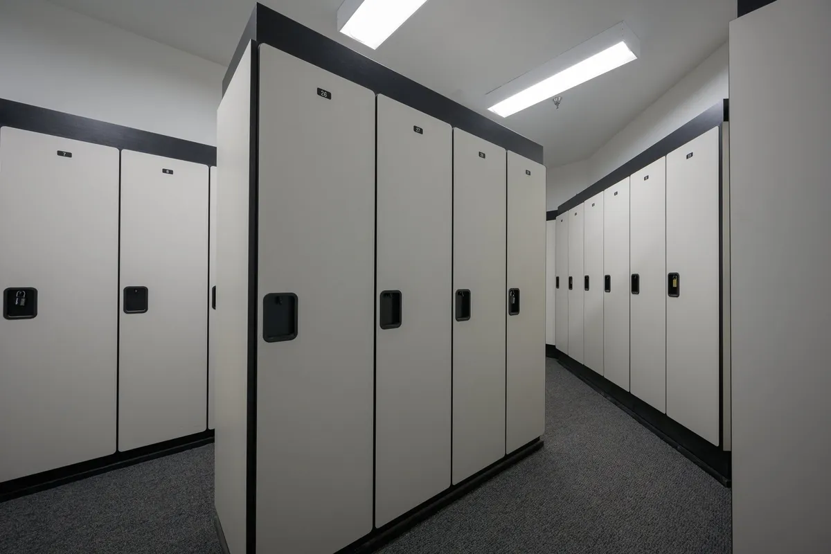 A tidy row of modern ski and bike lockers in a practical, well-lit interior space. Secure lock mechanisms are visible, emphasizing convenience and guest security.